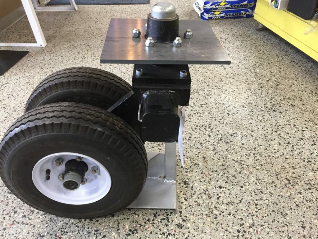 Trailer axle with mounting plate and tires on rims for utility trailer assembly
